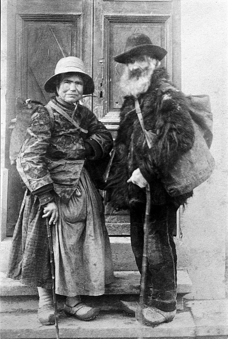 Couple de mendiants (paures) devant la porte de l'usine Reynès, à Lapeyre, vers 1900