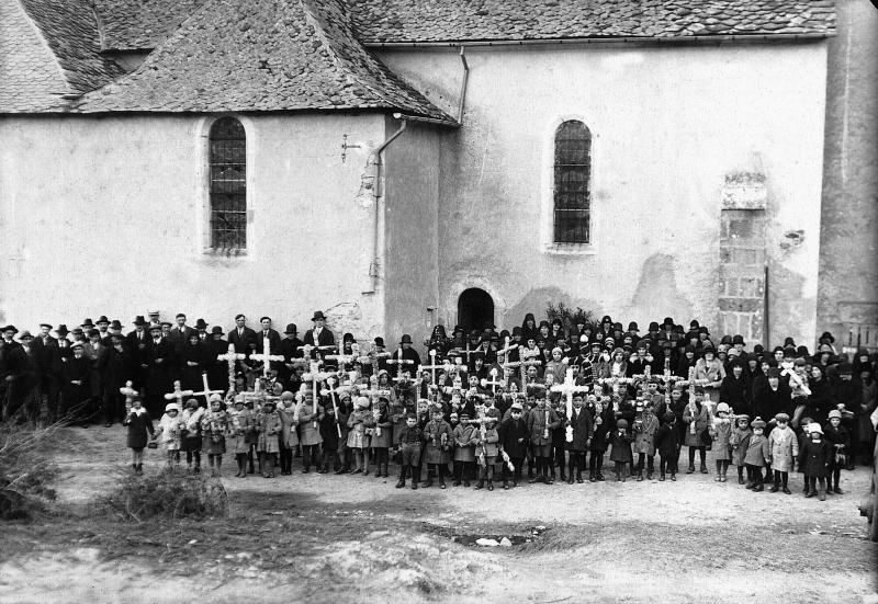 Paroissiens (parroquians) et enfants (dròlles, enfants) avec croix (crotz) avant un feu de joie pour une retraite, à Teulières, 1930